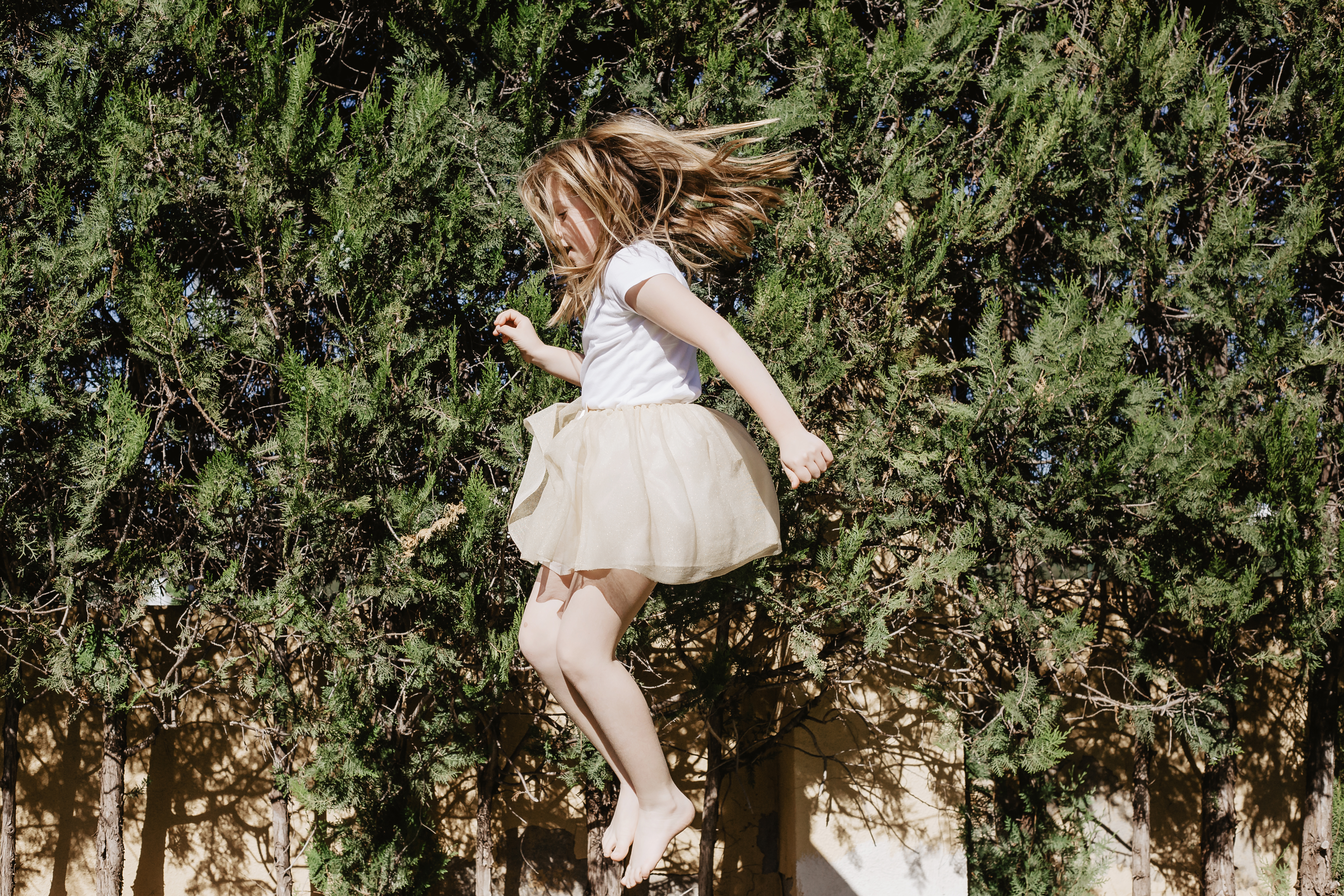 girl-dress-jumping-near-trees